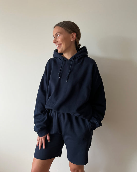 Our navy hoodie is the perfect lounge piece. Why not go oversized for ultimate comfort?